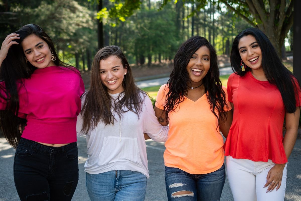 Group of four teenage female friends of different races